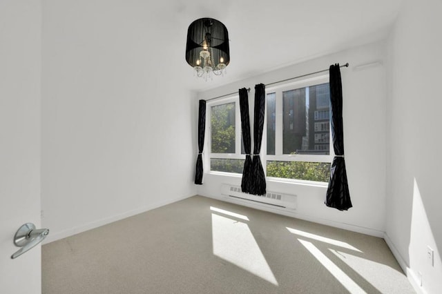 unfurnished room featuring light carpet and a notable chandelier