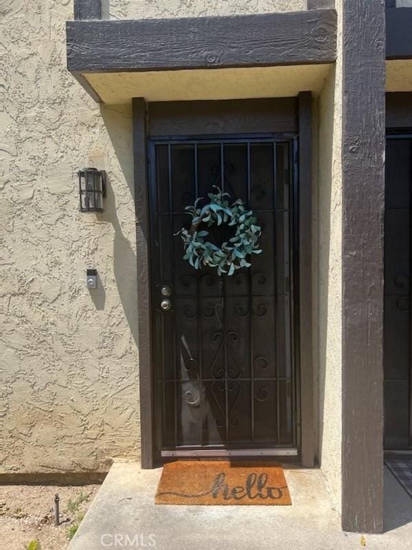 doorway to property with stucco siding