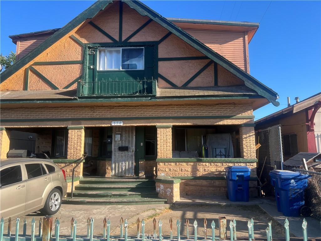 view of front of home featuring brick siding and a porch