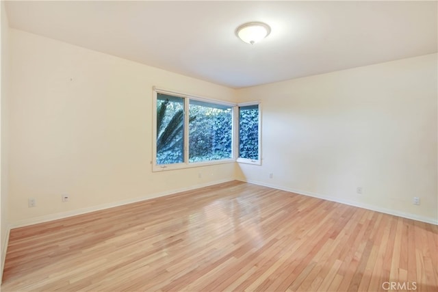 spare room featuring light hardwood / wood-style floors