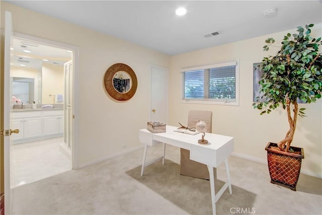 home office featuring light colored carpet and sink