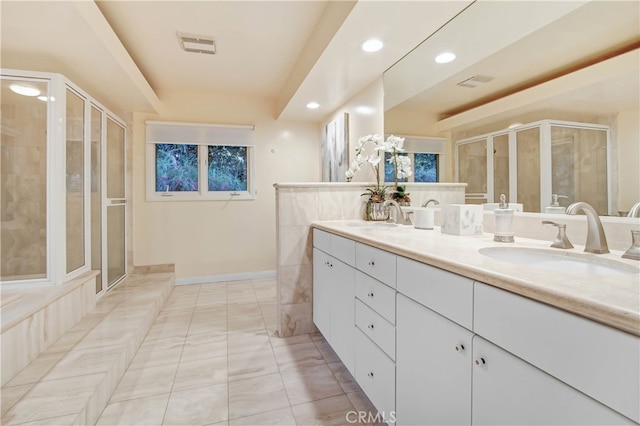 bathroom featuring tile patterned floors, vanity, and a shower with door