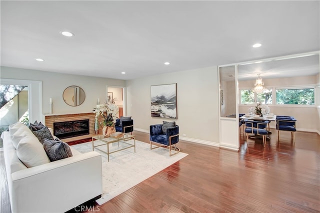 living room with hardwood / wood-style floors and a notable chandelier