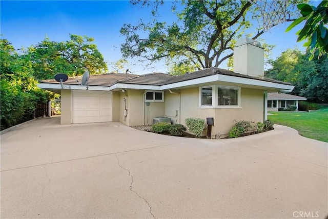 view of front of house with a garage and a front yard