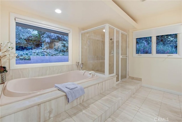 bathroom with tile patterned floors and shower with separate bathtub