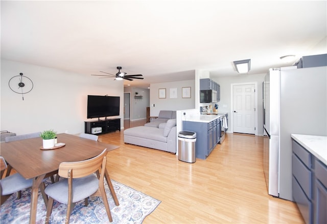 dining room featuring light hardwood / wood-style flooring and ceiling fan