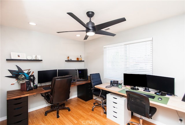 office space with light wood-type flooring and ceiling fan