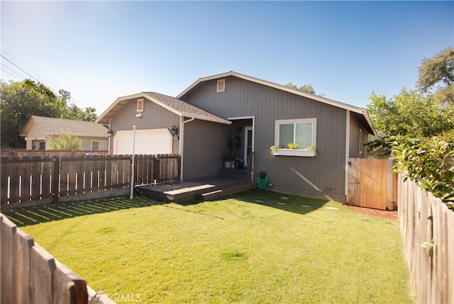 rear view of house featuring a lawn and a wooden deck