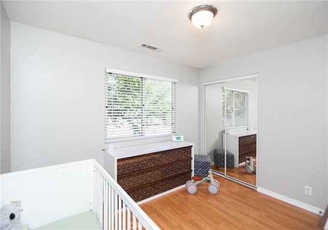 bedroom featuring hardwood / wood-style flooring and a closet