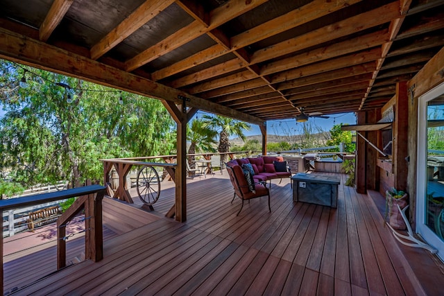 deck with ceiling fan and a hot tub