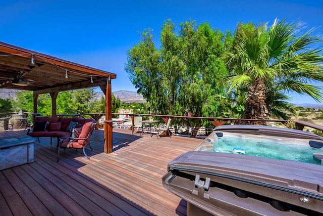 wooden deck with a mountain view and ceiling fan