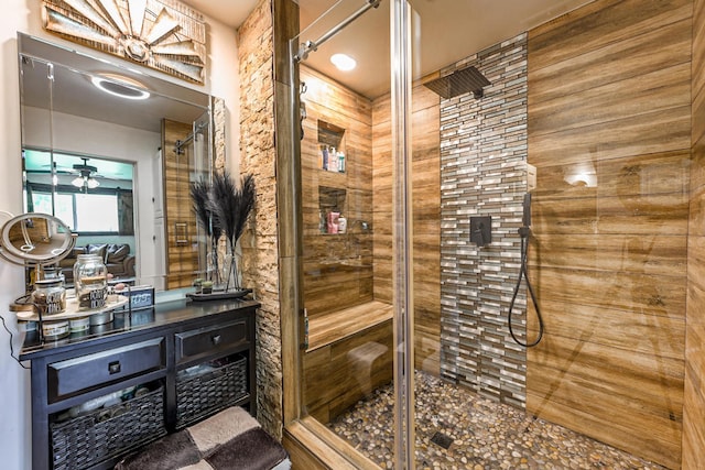 bathroom featuring vanity, ceiling fan, and an enclosed shower