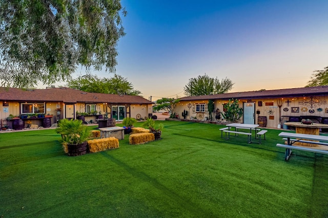 yard at dusk with a patio area