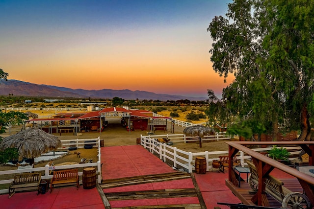 patio terrace at dusk featuring a mountain view