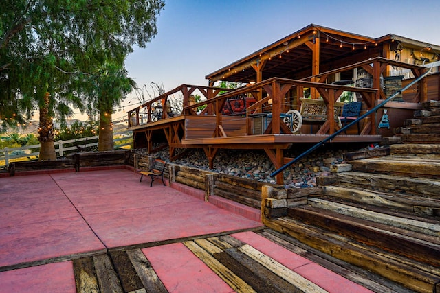 patio terrace at dusk featuring a deck