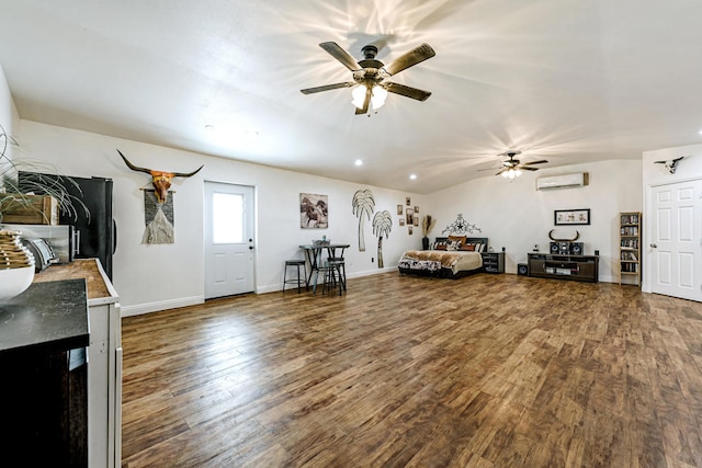 unfurnished living room featuring hardwood / wood-style floors, ceiling fan, and a wall mounted air conditioner