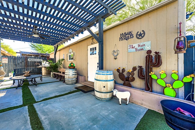 view of patio / terrace with ceiling fan and a pergola