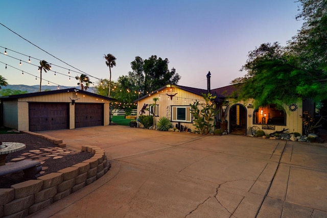 view of front of property featuring an outdoor structure and a garage