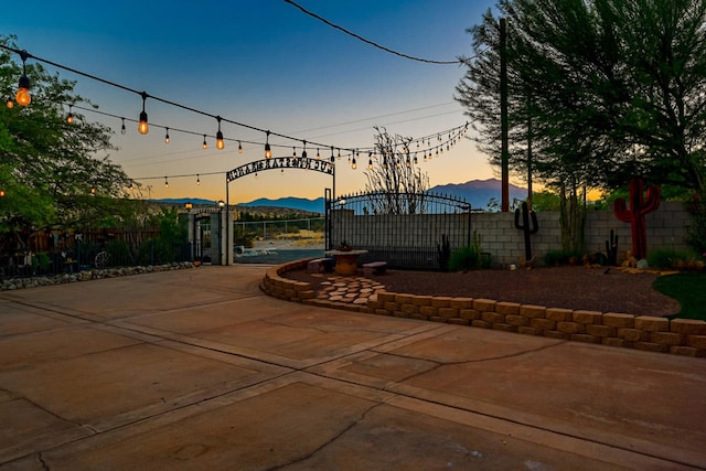 patio terrace at dusk featuring a mountain view