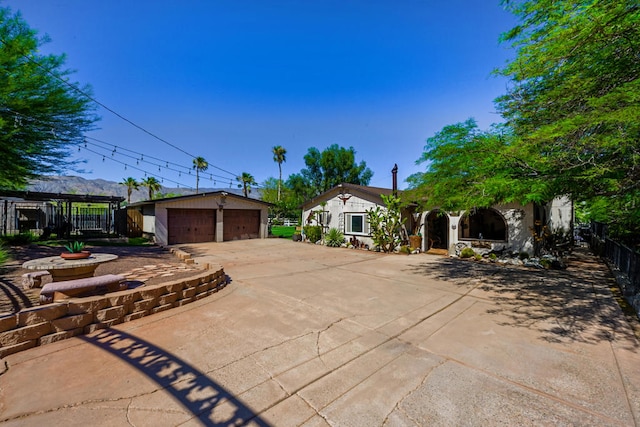 view of front of home featuring a mountain view, a garage, and an outbuilding