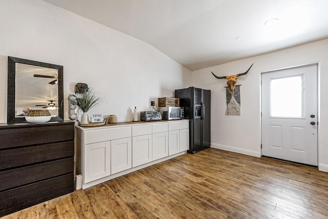 interior space featuring lofted ceiling and hardwood / wood-style flooring