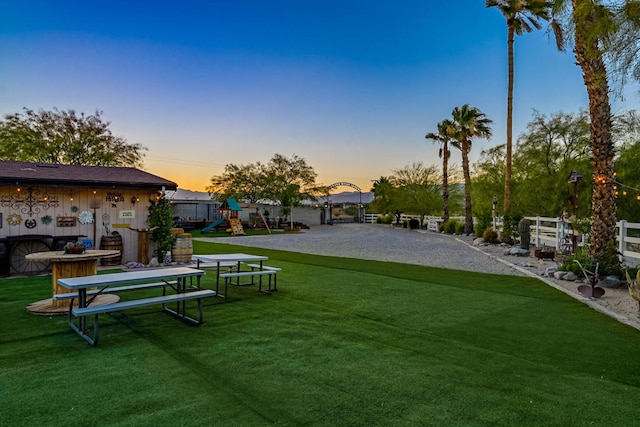 view of community featuring a playground and a yard