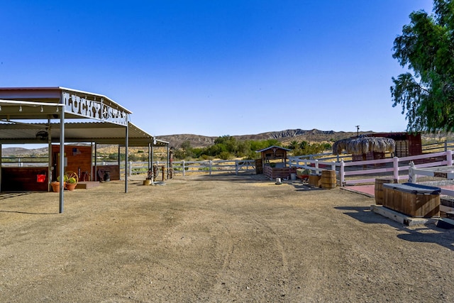 view of community featuring a mountain view, an outdoor structure, and a rural view