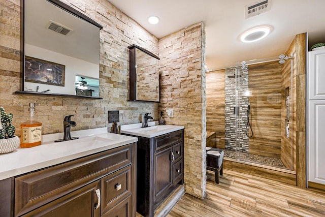 bathroom with vanity, wood-type flooring, and a shower with shower door