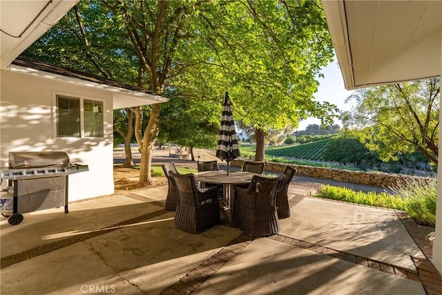 view of patio with area for grilling and outdoor dining space