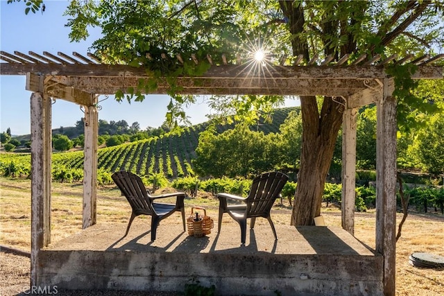 view of patio featuring a pergola and a rural view
