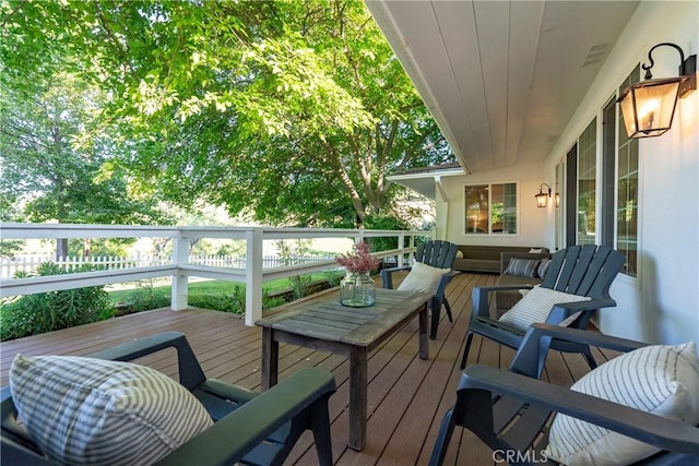 wooden deck featuring visible vents