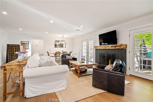 living room featuring ornamental molding, recessed lighting, wood finished floors, and a wealth of natural light