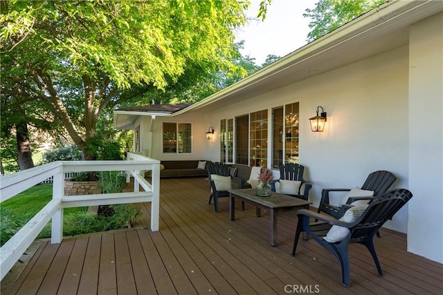 wooden terrace with outdoor lounge area