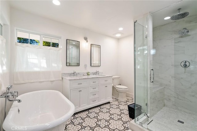 bathroom with double vanity, a freestanding tub, a sink, and a stall shower