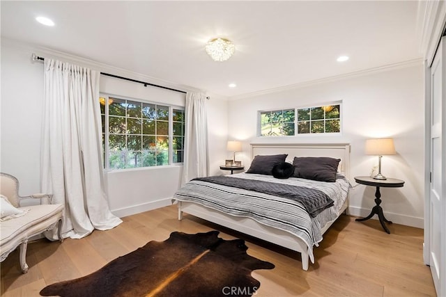 bedroom featuring baseboards, ornamental molding, light wood-style floors, and recessed lighting