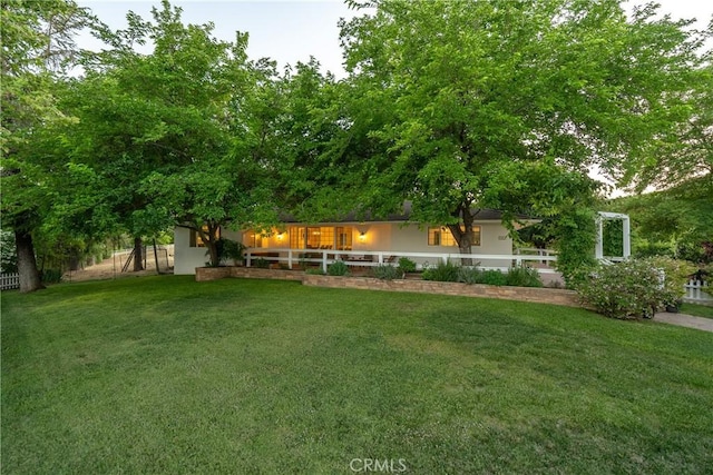 view of yard with a porch and fence