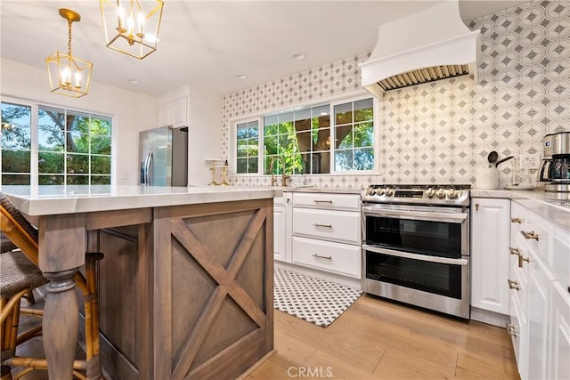 kitchen featuring appliances with stainless steel finishes, custom exhaust hood, white cabinets, and tasteful backsplash