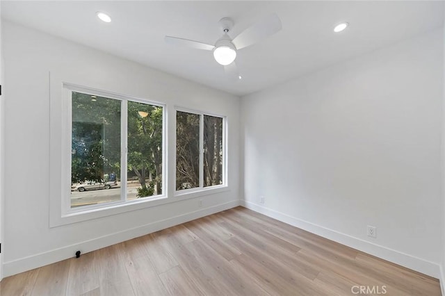 spare room with light hardwood / wood-style floors and ceiling fan