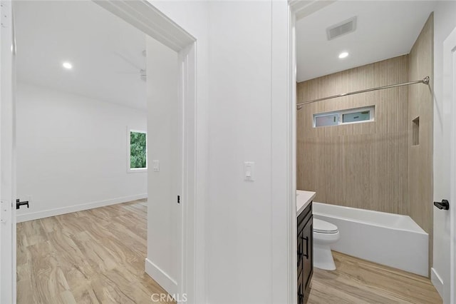 full bathroom with vanity, toilet, wood-type flooring, and bathtub / shower combination