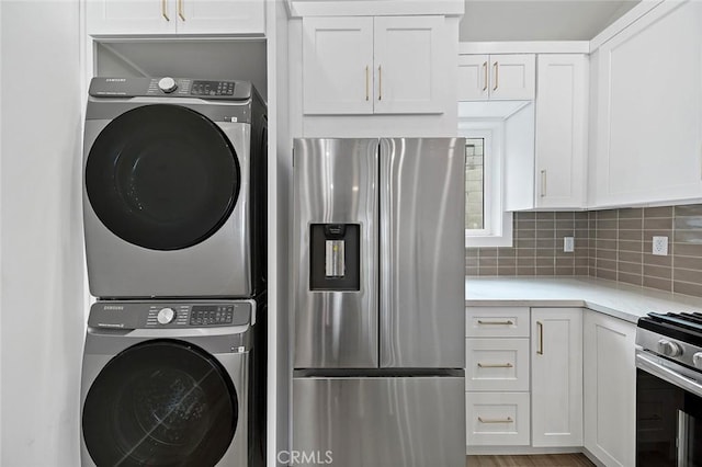 laundry area featuring stacked washer / drying machine