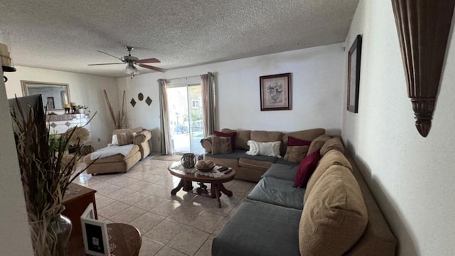 living room featuring a textured ceiling, ceiling fan, and light tile patterned floors