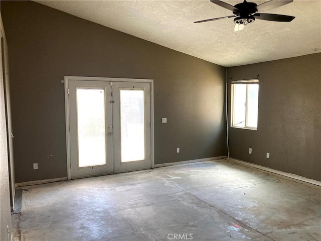 empty room with ceiling fan, french doors, and a textured ceiling