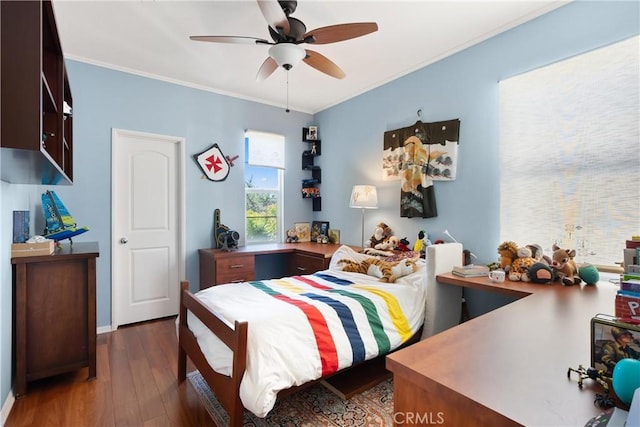 bedroom with dark hardwood / wood-style floors, ceiling fan, and crown molding