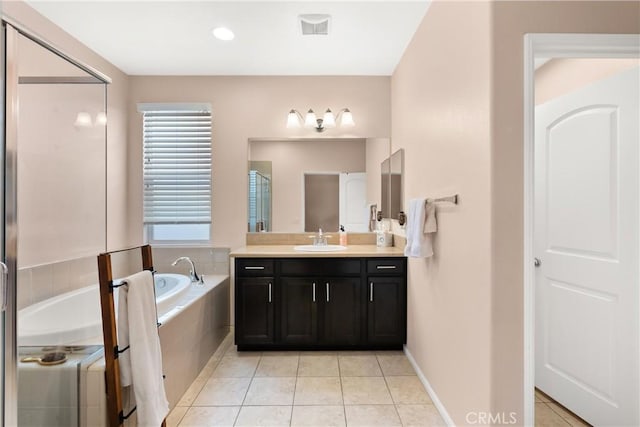 bathroom featuring tile patterned floors, vanity, and shower with separate bathtub