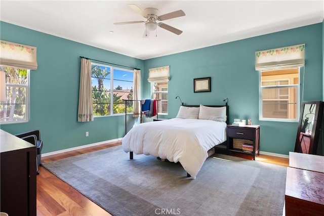 bedroom with hardwood / wood-style flooring and ceiling fan