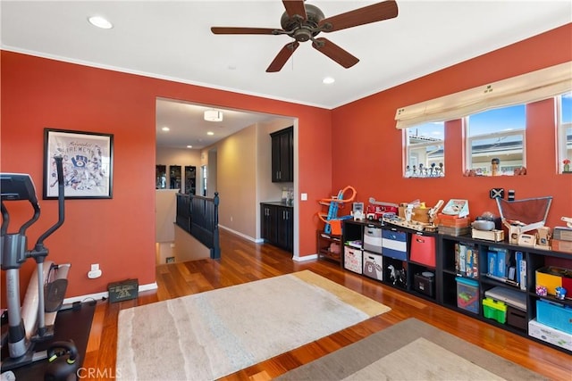 playroom featuring hardwood / wood-style floors, ceiling fan, and crown molding