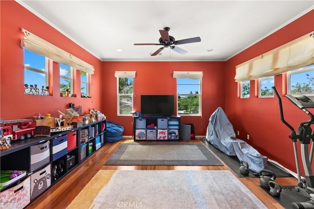 playroom featuring hardwood / wood-style floors, ceiling fan, and ornamental molding