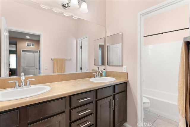 full bathroom with tile patterned flooring, vanity, toilet, and shower / washtub combination