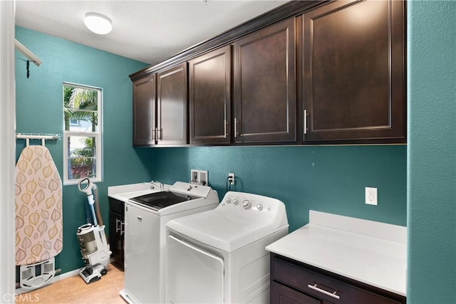 laundry area with cabinets, sink, and washing machine and clothes dryer