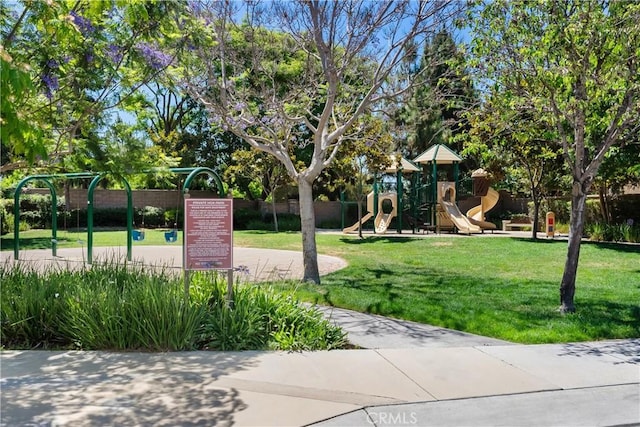 view of community featuring a playground and a yard